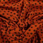 Tissu Jersey Coton Bio Pois déstructurés noirs sur fond Rouille - Par 10 cm
